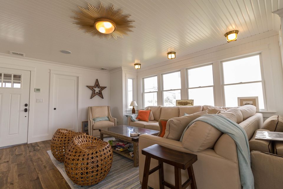 Beach house living room with a sunburst light fixture