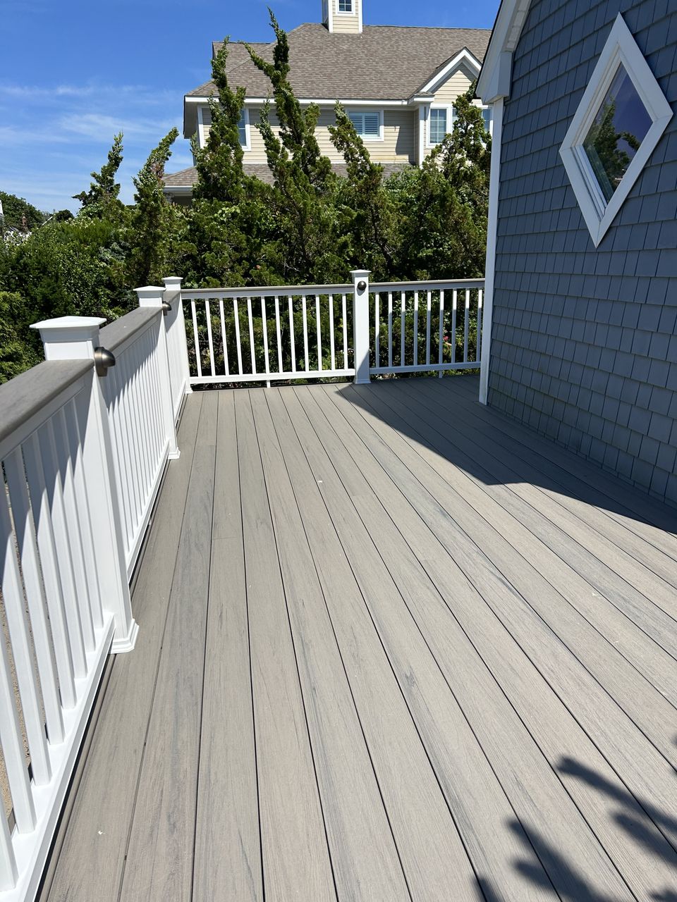 Gray composite deck boards with white vinyl rails