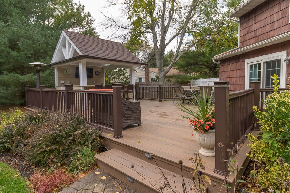 Deck and cabana framed by landscaping