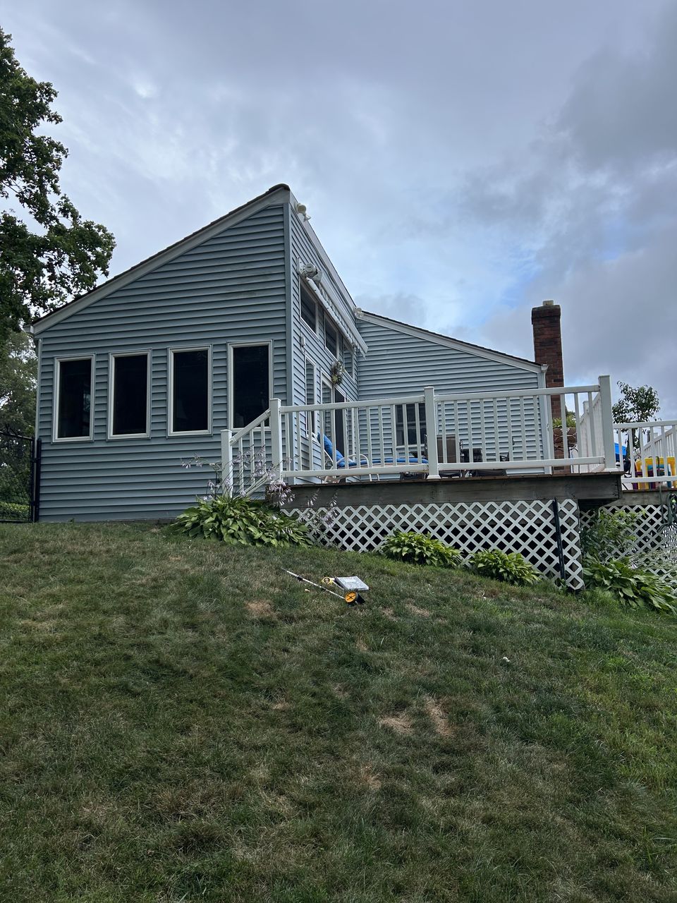 Deck with lattice skirting above a sloped lawn