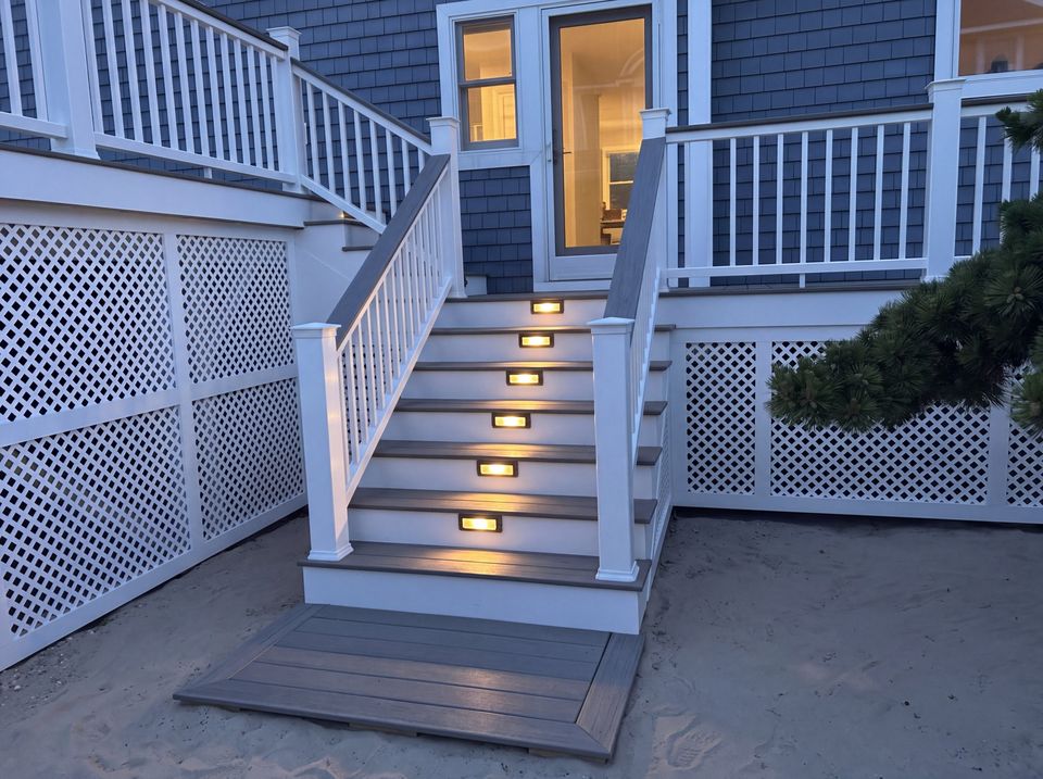 Deck stairs with recessed riser lights glowing at dusk