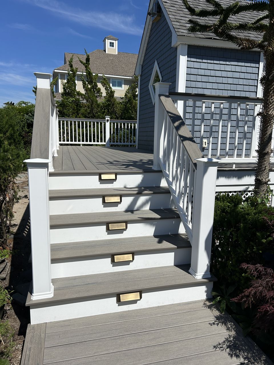 Deck stairs with gray composite treads and recessed riser lights