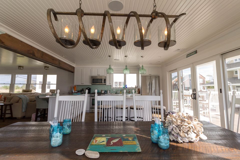 Dining table under an iron chandelier in an open plan