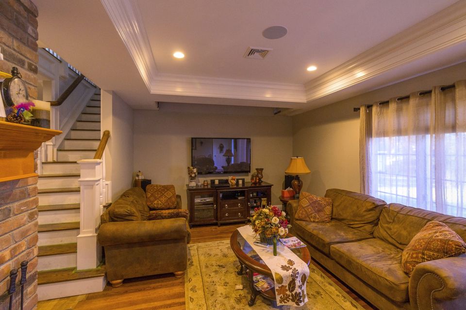 Family room with an open stair and a tray ceiling