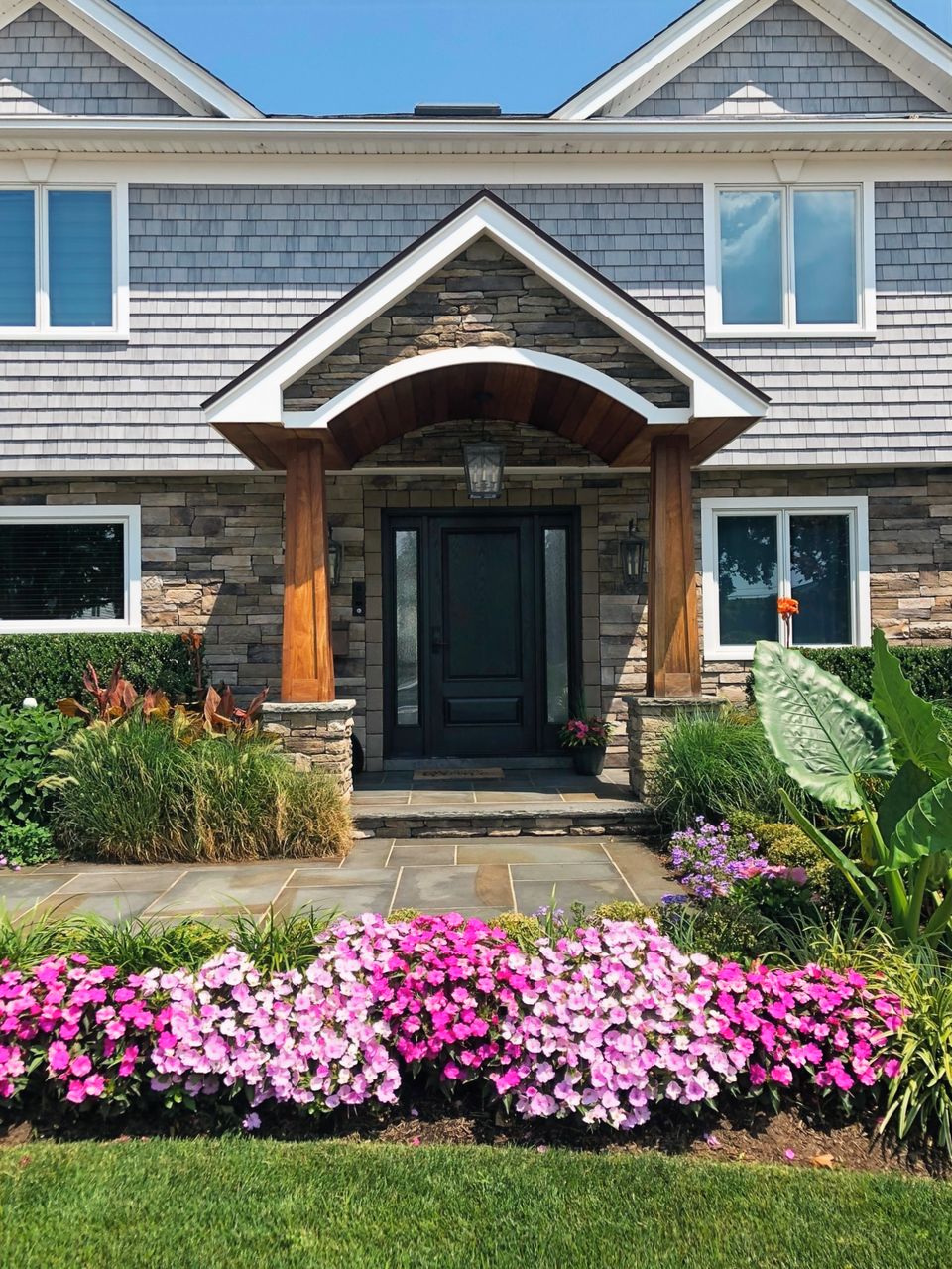 Front portico with stone and timber columns and a bluestone walk