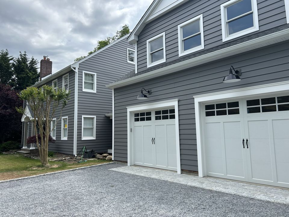 Gray sided garage addition with carriage style doors