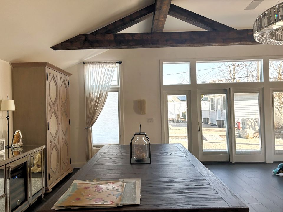 Great room with timber trusses and French doors
