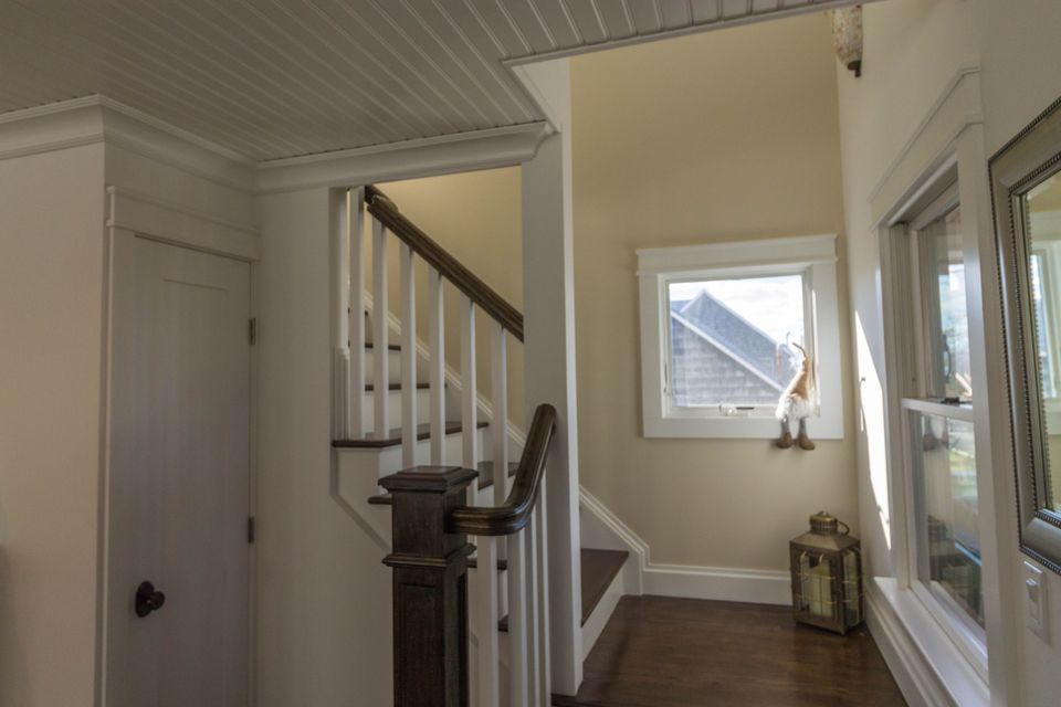 Hallway with a stair and painted doorway trim