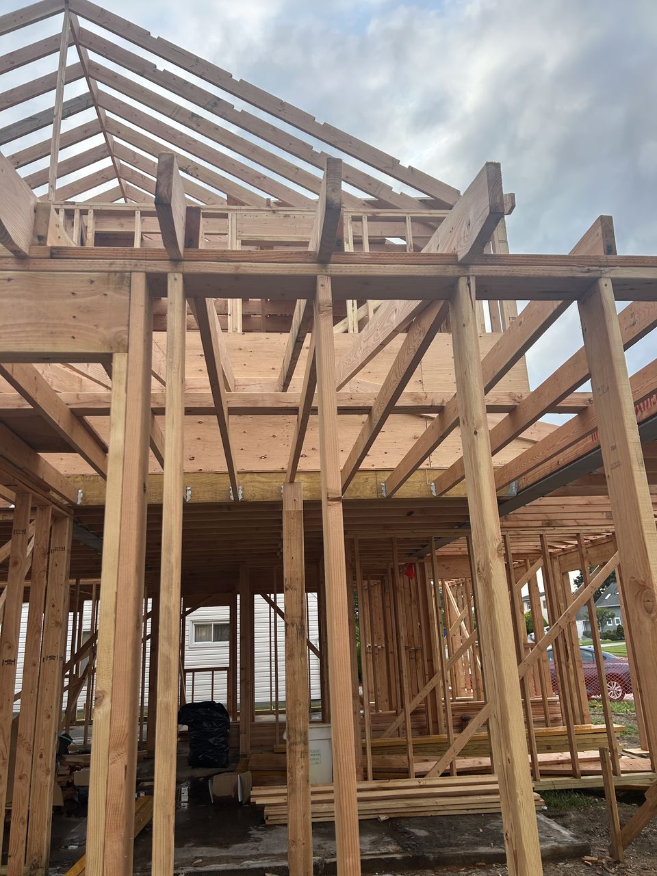 Inside the framing of a new build, looking up at the second floor and rafters