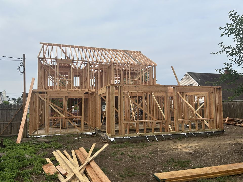 Two story new build framed in lumber, seen from the yard
