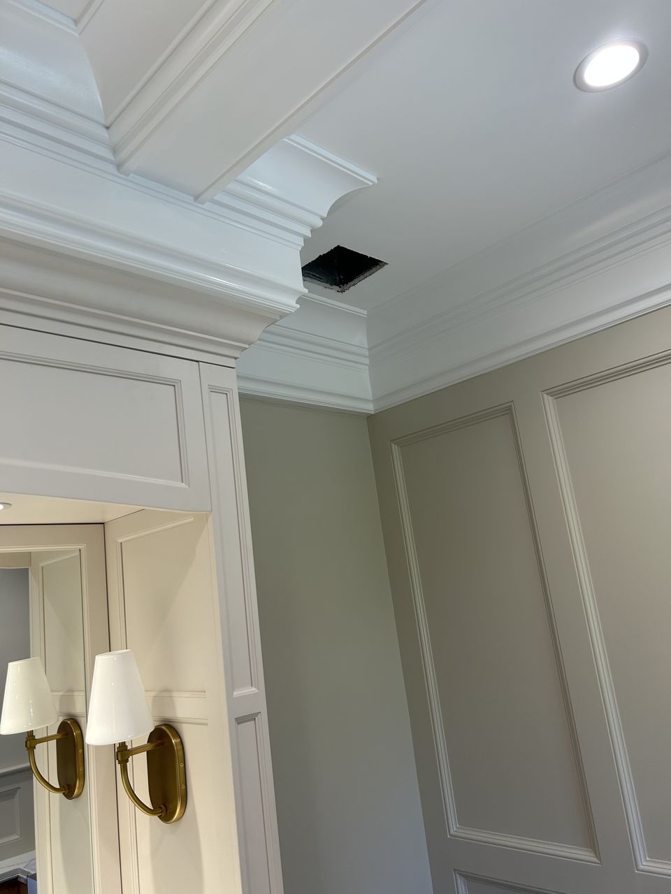 Coffered ceiling corner above paneled walls