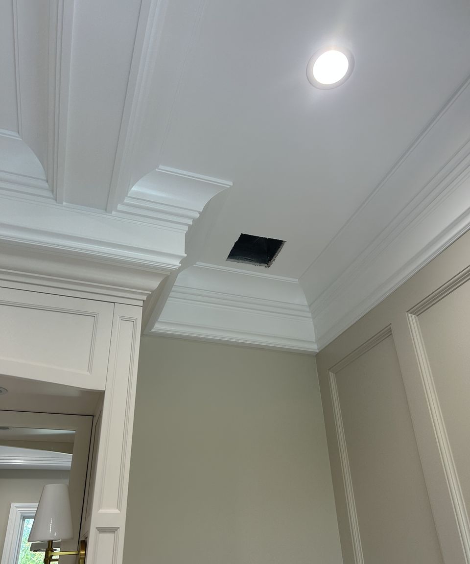 Stacked crown molding where the coffered ceiling meets the paneling