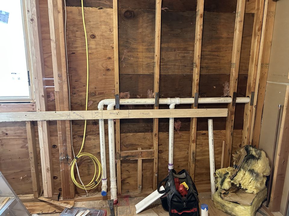The bath taken down to the studs, with new plumbing roughed in
