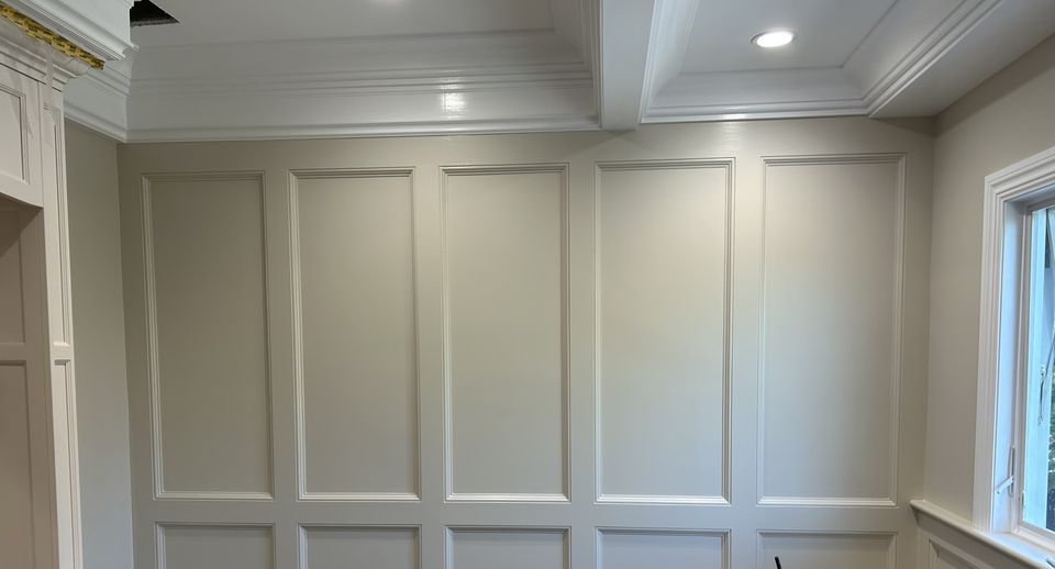 Paneled bath walls under a coffered ceiling
