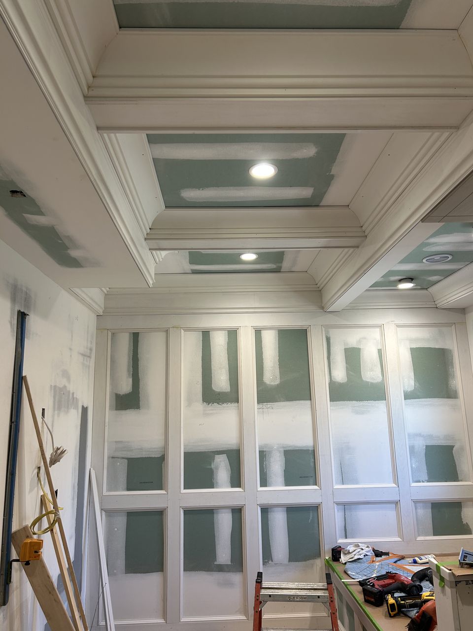 Paneled walls and the coffered ceiling before paint