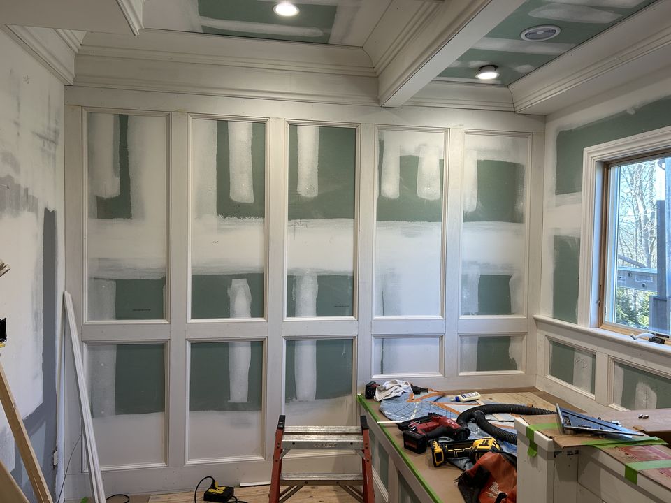 Wall paneling being built over the drywall