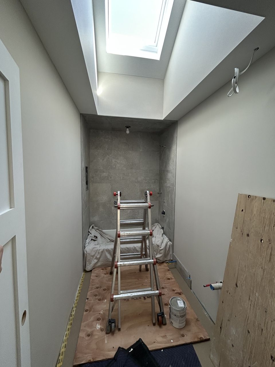 Shower alcove under a skylight, ready for tile