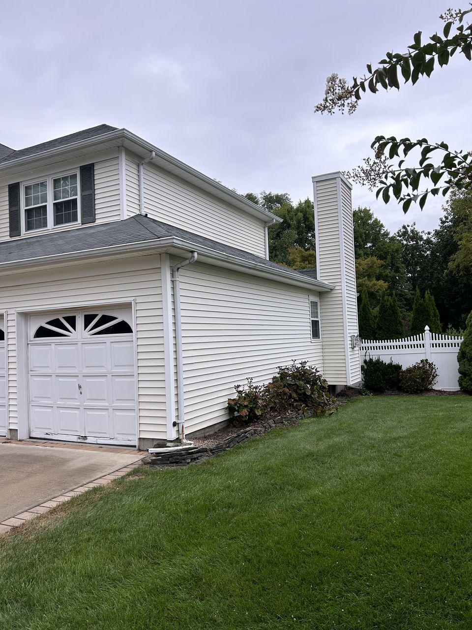Before: garage side of the house in white vinyl siding
