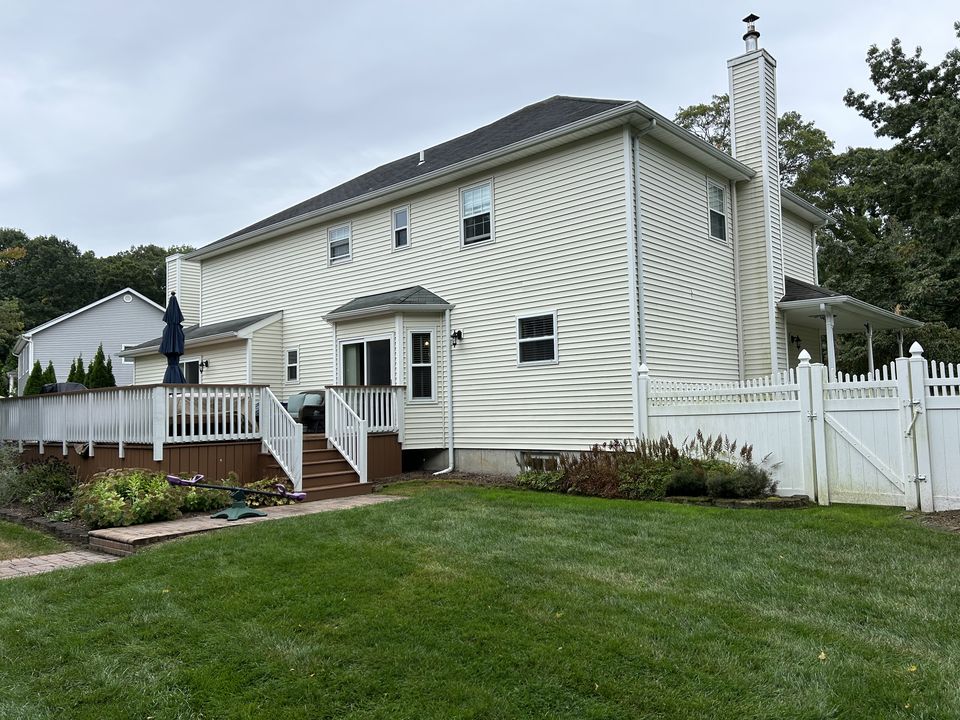 Before: rear of the house and the deck from the yard