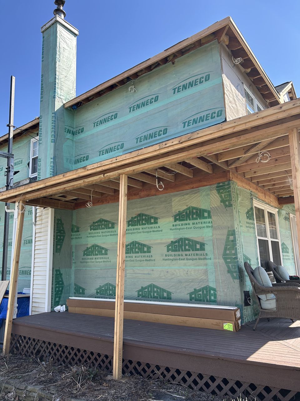 New covered porch framed over the deck, with the walls in house wrap