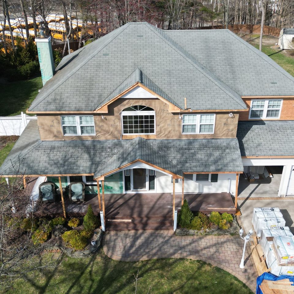 The front from the air during the rebuild, in house wrap with the new portico framed