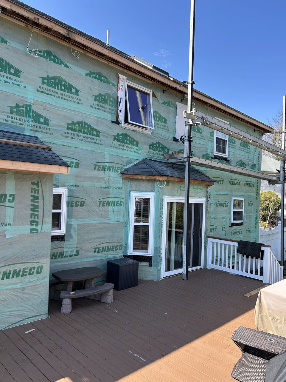 Rear of the house in house wrap above the deck