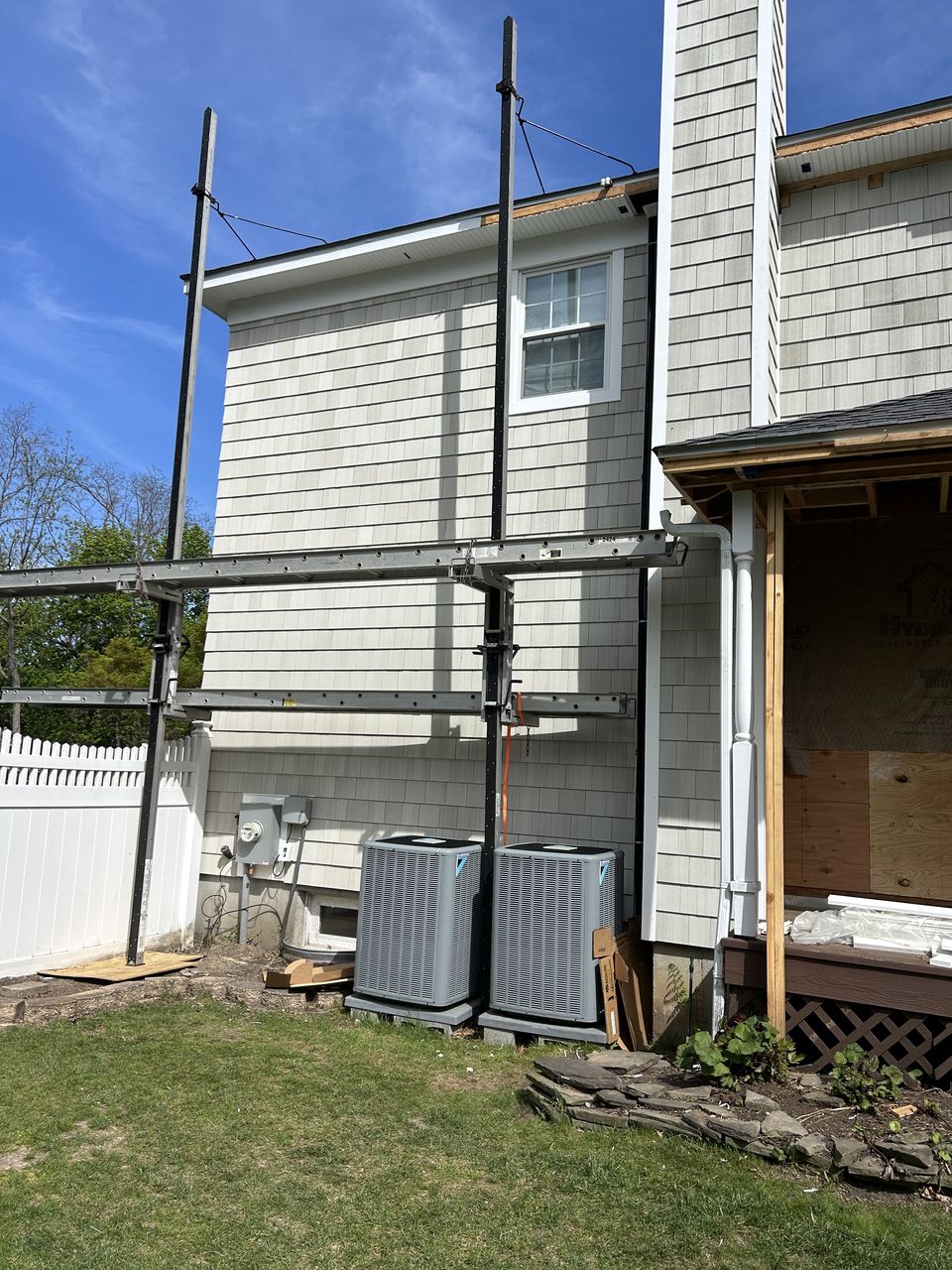 Side of the house in cedar shake, with the covered porch still open