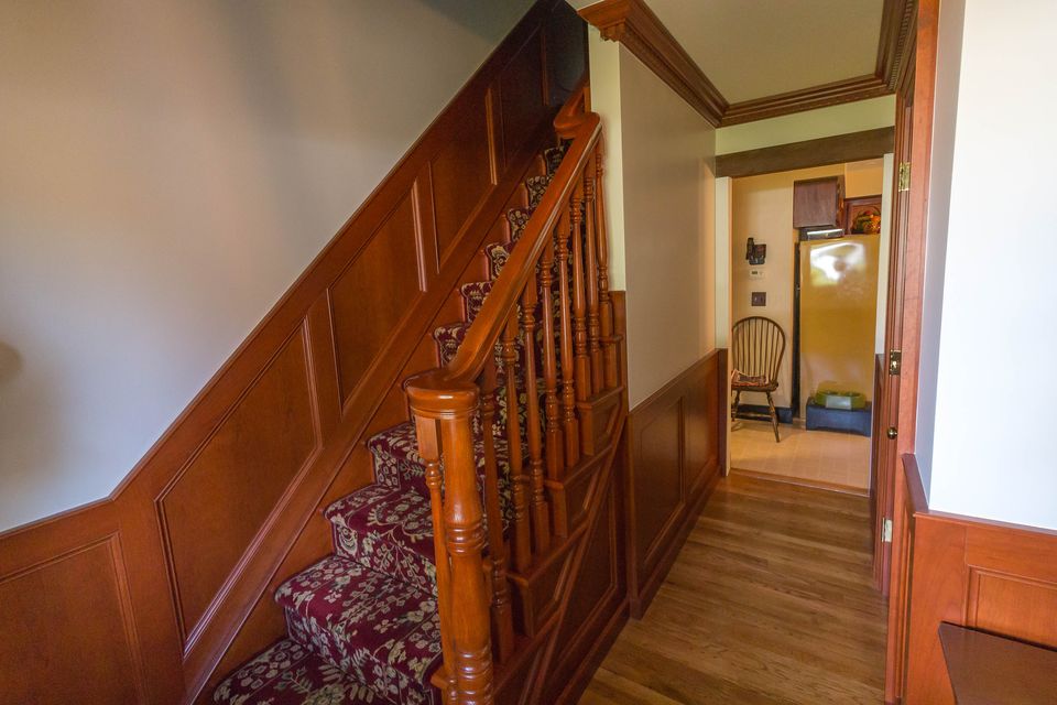 Stair and hall with wood wainscot